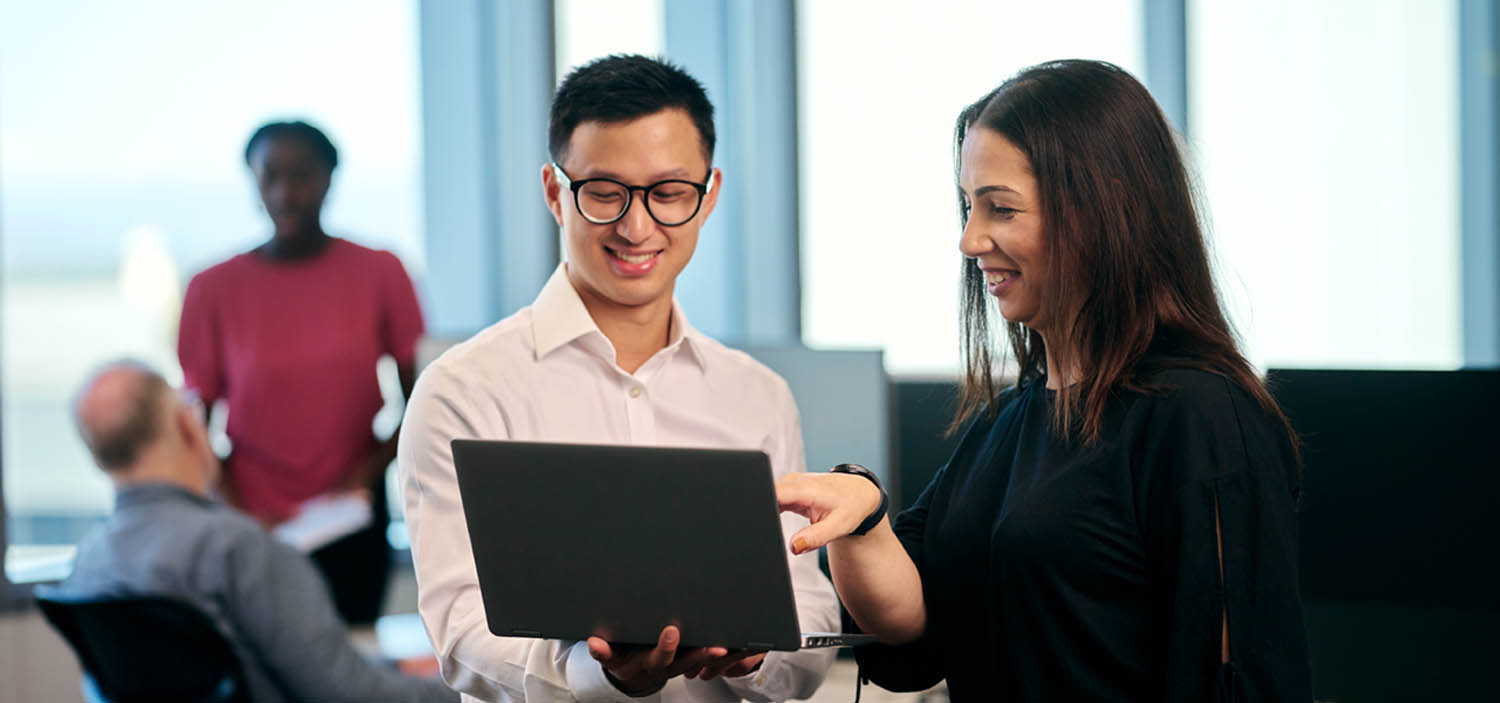 People in a meeting, working on a laptop