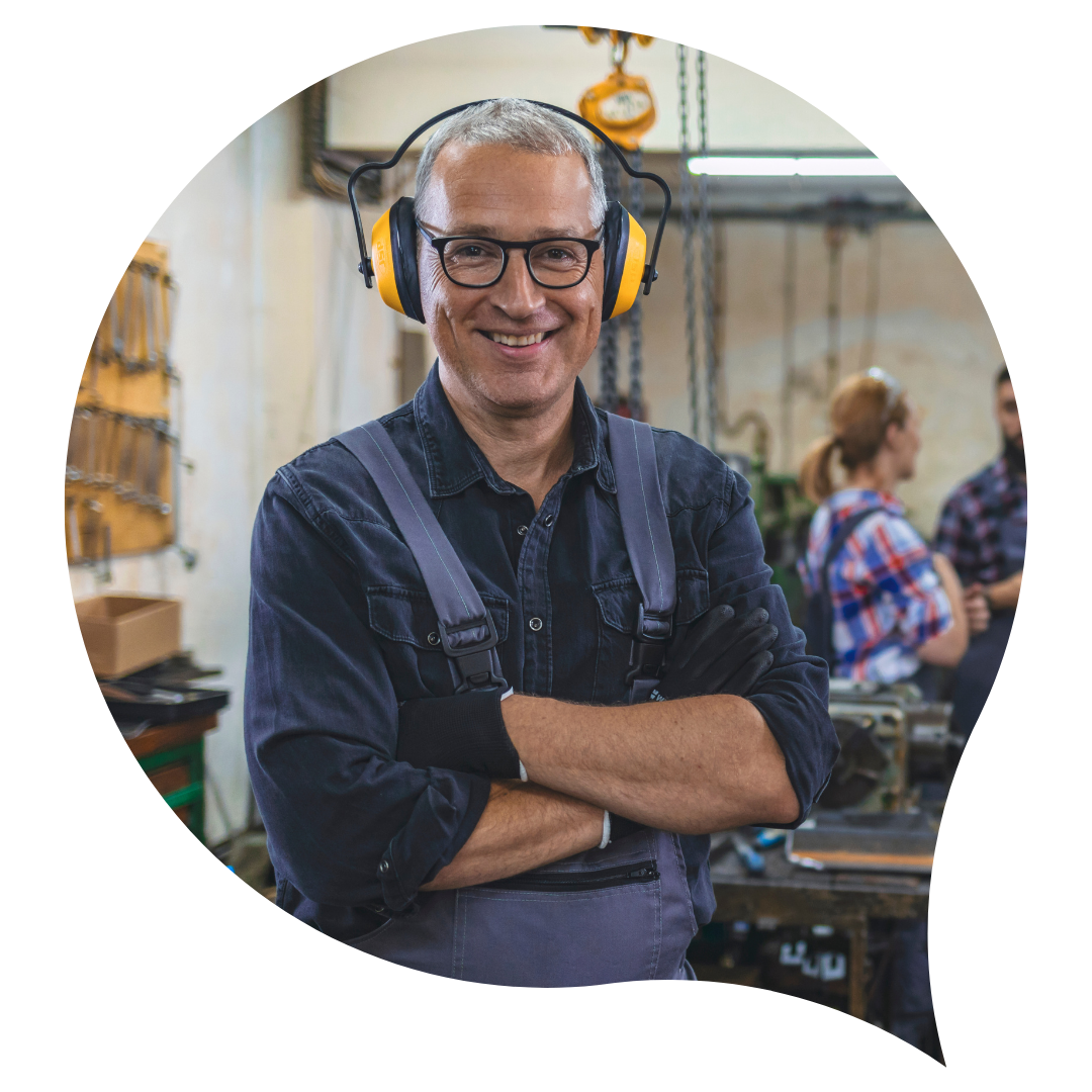 man standing in dark blue clothes wearing earmuffs and safety glasses