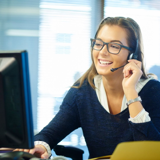 An employee sitting at a desk in the office working on their computer